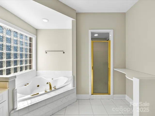 a bathroom with a bathtub and shower