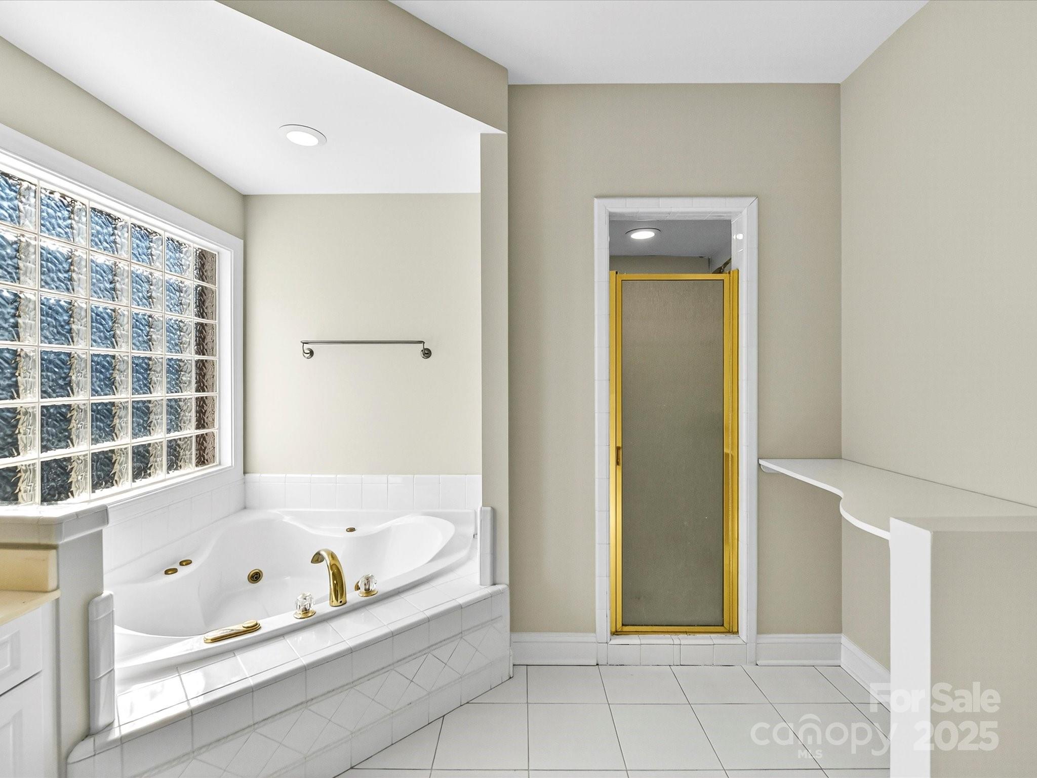 21410 Pinecrest Place Cornelius, NC 28031 - Photo 24 of 43 a bathroom with a bathtub and shower