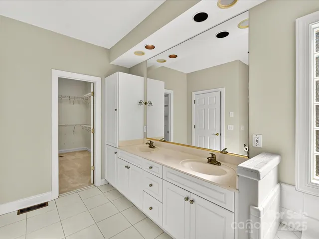 a bathroom with a double vanity sink mirror and