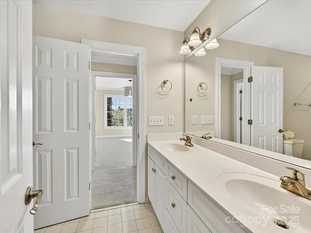 a spacious bathroom with a double vanity sink mirror and