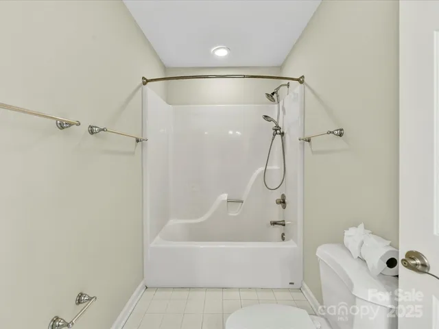 a bathroom with a shower and a bath tub