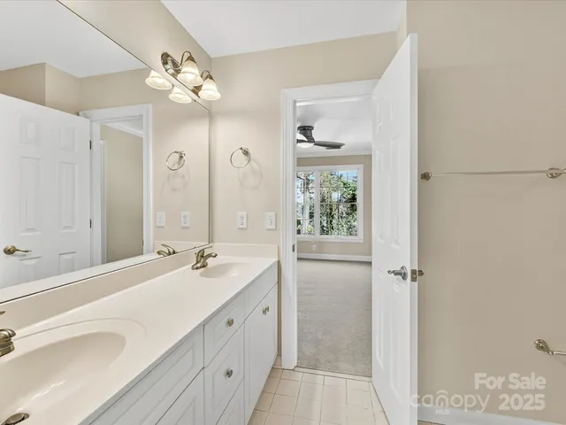 a bathroom with a double vanity sink mirror and double