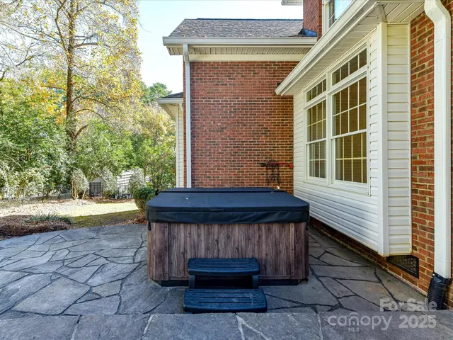 a view of backyard with barbeque grill and wooden fence