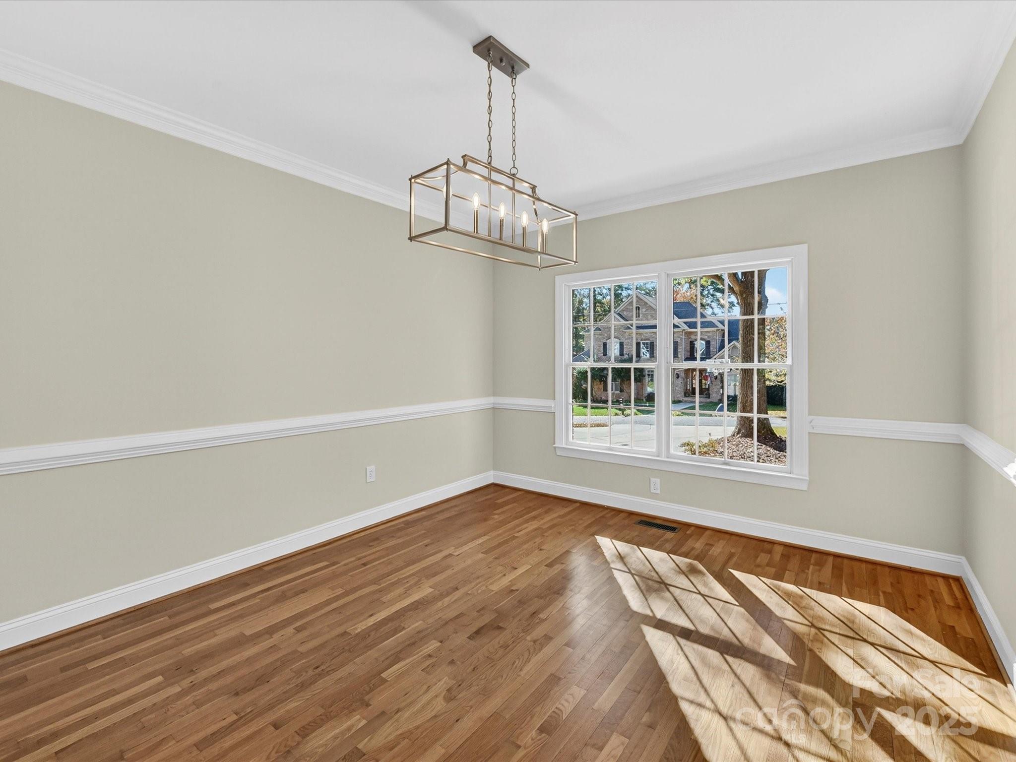 21410 Pinecrest Place Cornelius, NC 28031 - Photo 5 of 43 a view of an empty room with wooden floor and a window
