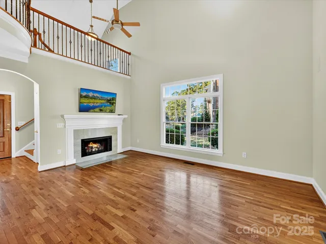 a view of livingroom with furniture a fireplace and wooden floor