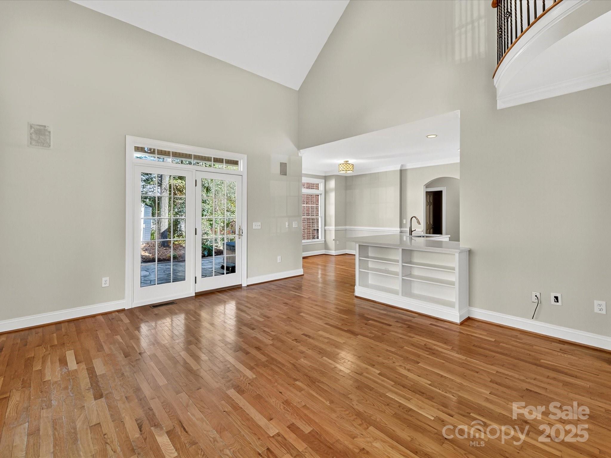 21410 Pinecrest Place Cornelius, NC 28031 - Photo 10 of 43 a view of an empty room with wooden floor and a window