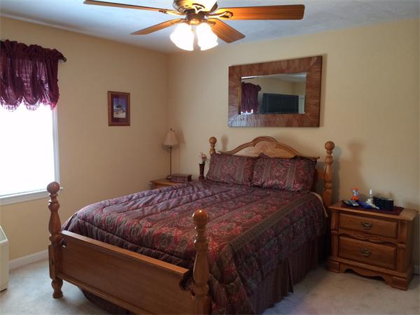 240 Pleasantdale Road Rutland, MA 01543 - Photo 11 of 25 a bedroom with a bed and a chandelier