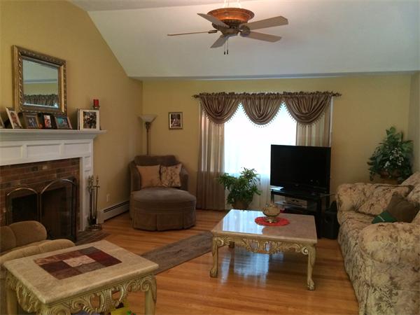 240 Pleasantdale Road Rutland, MA 01543 - Photo 7 of 25 a living room with furniture a flat screen tv and a fireplace