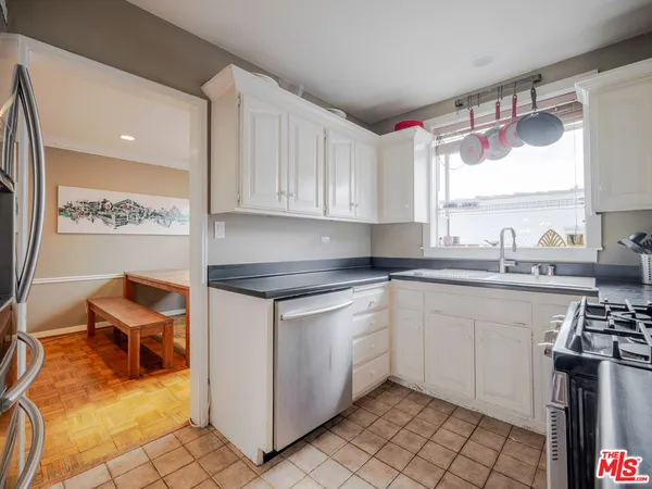 a kitchen with a sink cabinets and window