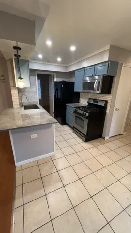 a kitchen with stainless steel appliances granite countertop a sink and a stove top oven