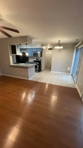 a view of a kitchen with cabinets and wooden floor