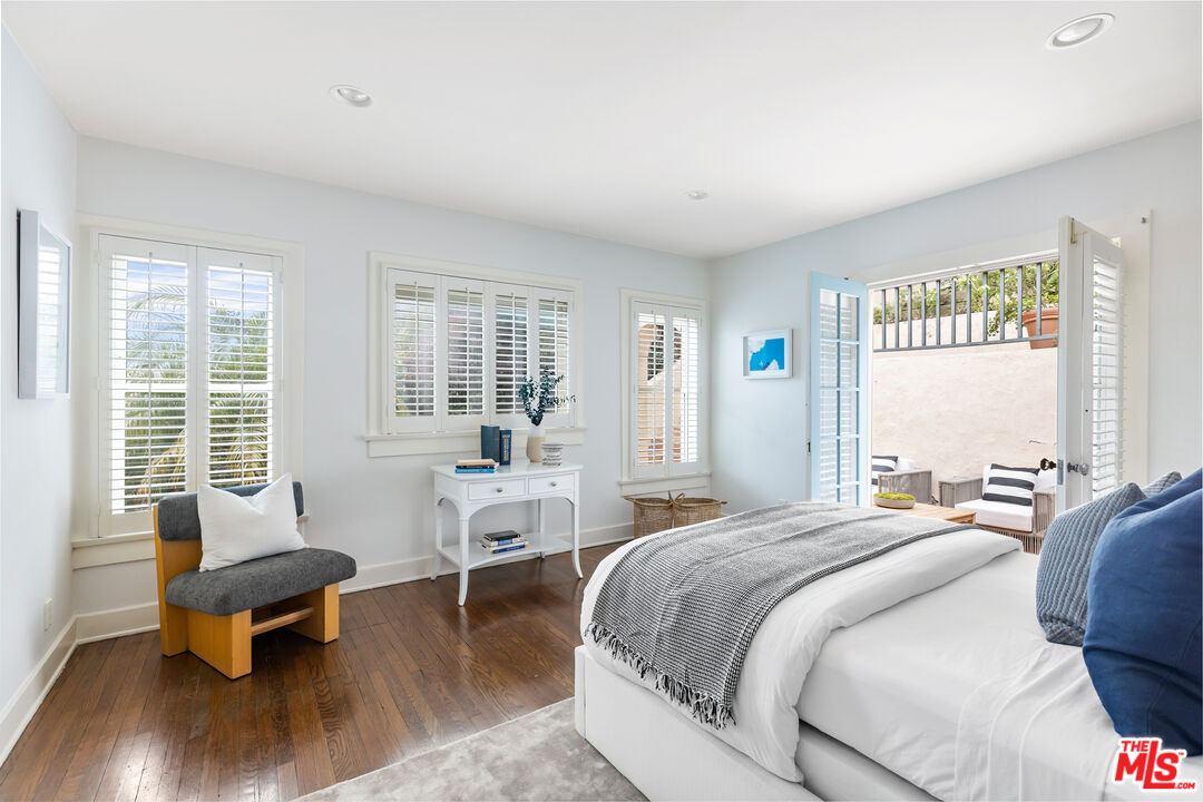 175 West Channel Road Santa Monica, CA 90402 - Photo 18 of 27 a spacious bedroom with a bed and large windows