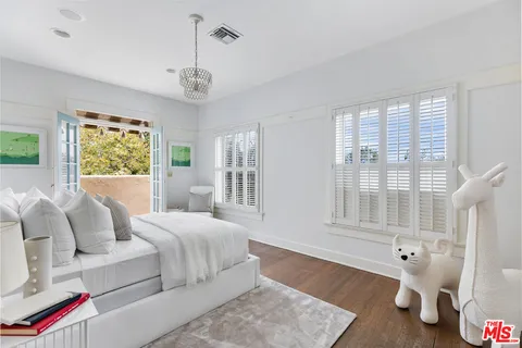 a bedroom with furniture and a window