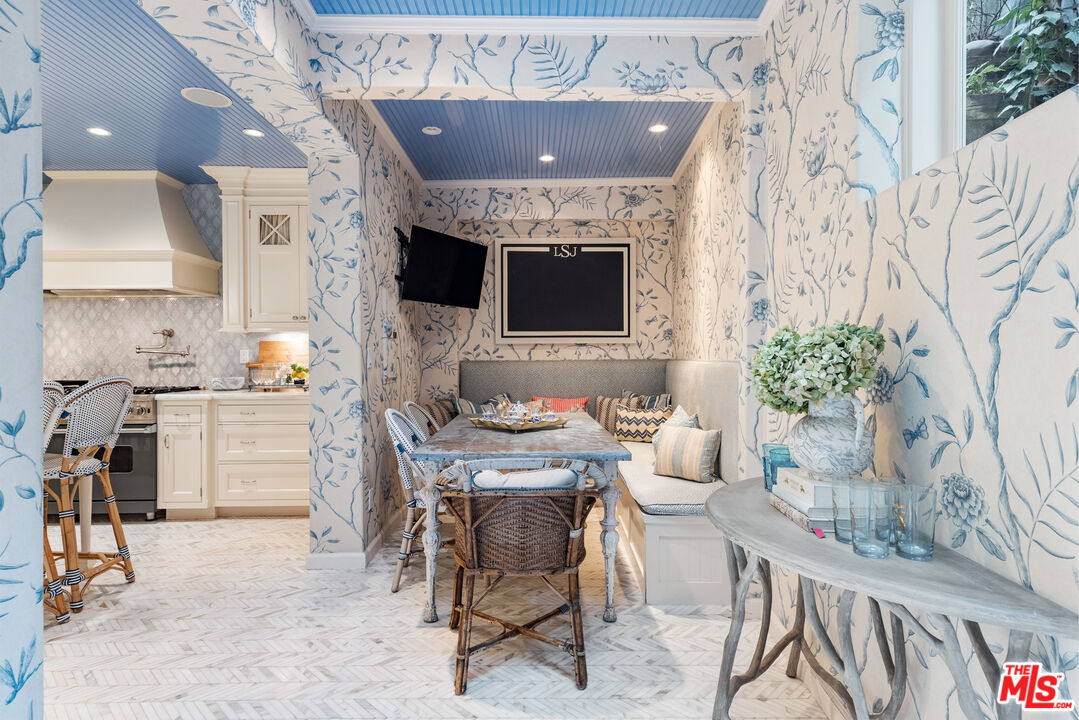 175 West Channel Road Santa Monica, CA 90402 - Photo 10 of 27 a living room with furniture a flat screen tv and a fireplace