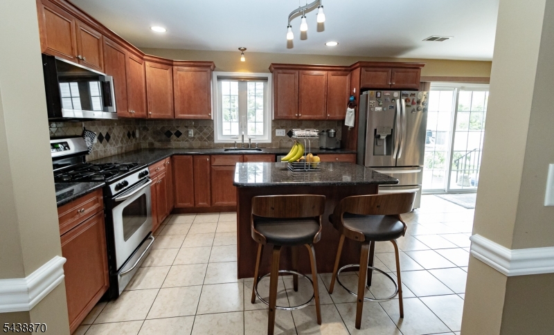 419 Putnam Road Union, NJ 07083 - Photo 13 of 37 a kitchen with stainless steel appliances granite countertop a stove a sink and a refrigerator