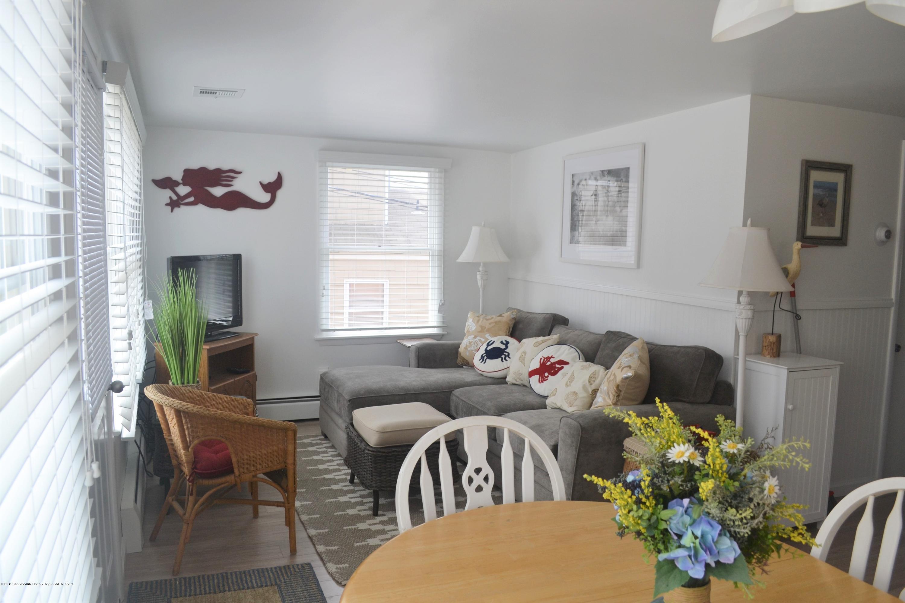 66 1st Avenue Manasquan, NJ 08736 - Photo 4 of 14 a bedroom with a bed couch and window
