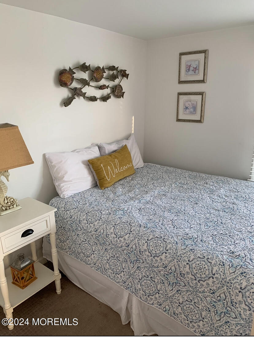 66 1st Avenue Manasquan, NJ 08736 - Photo 5 of 14 a bedroom with a bed and cabinets