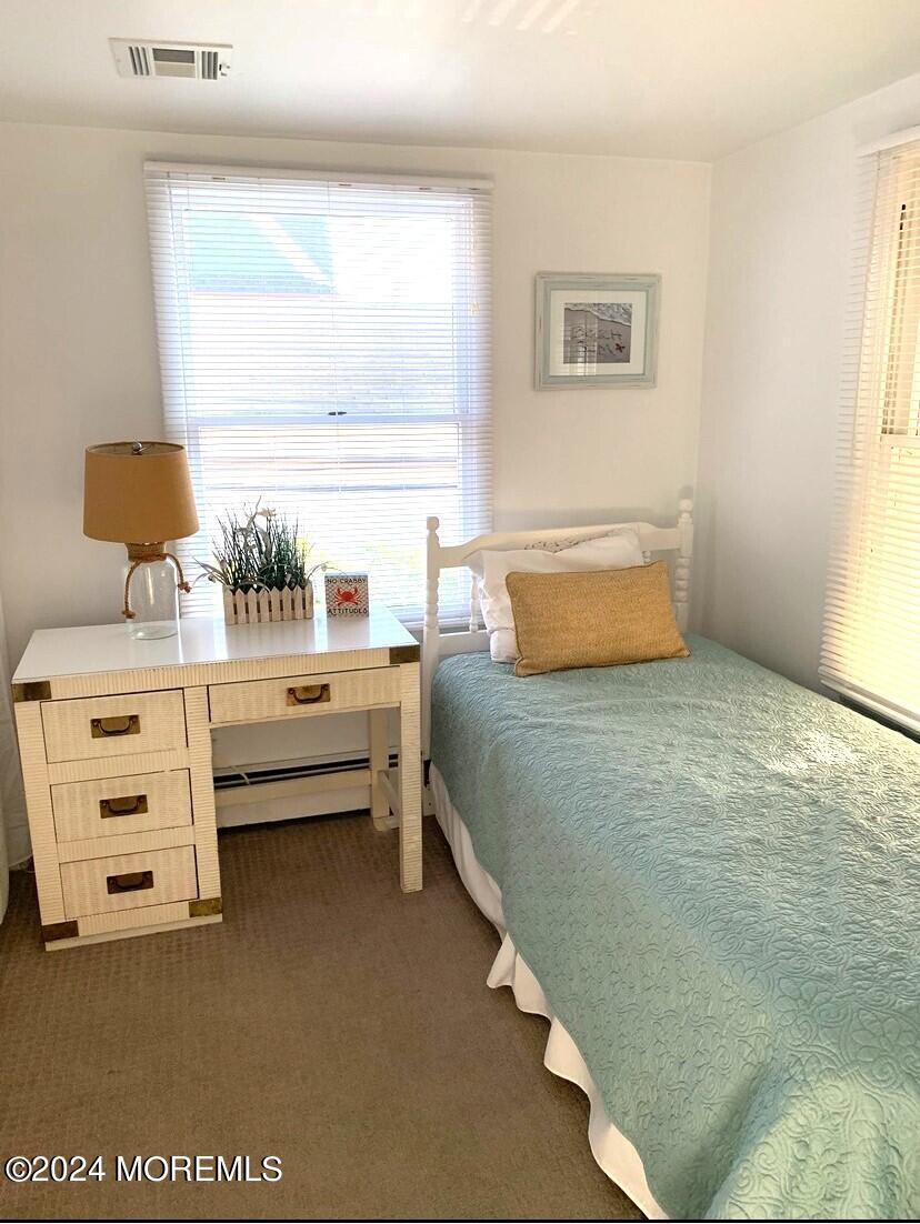 66 1st Avenue Manasquan, NJ 08736 - Photo 7 of 14 a bedroom with furniture and window
