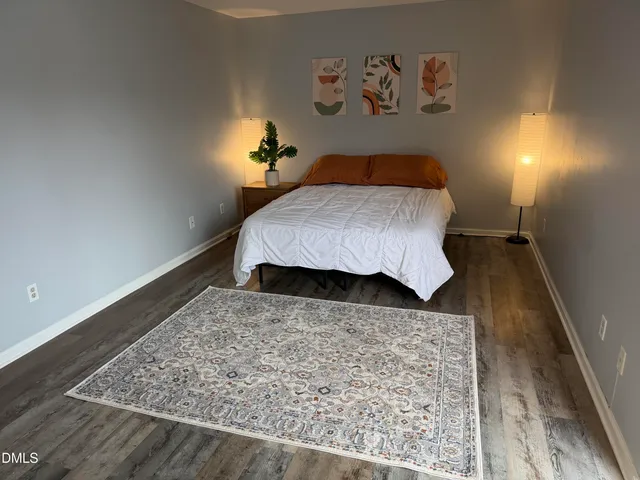 a bedroom with a bed and a dresser