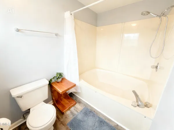 a white toilet sitting next to a bathroom sink and a window