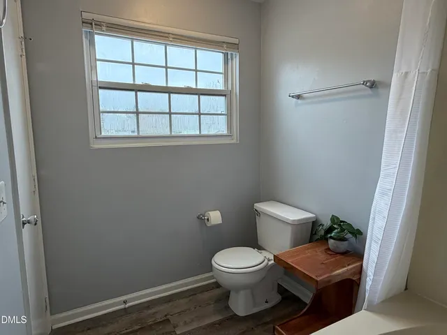 a white toilet sitting next to a bathroom sink and shower