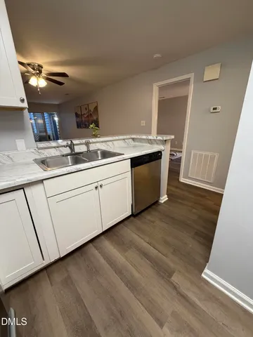 a kitchen that has a sink and a stove in it