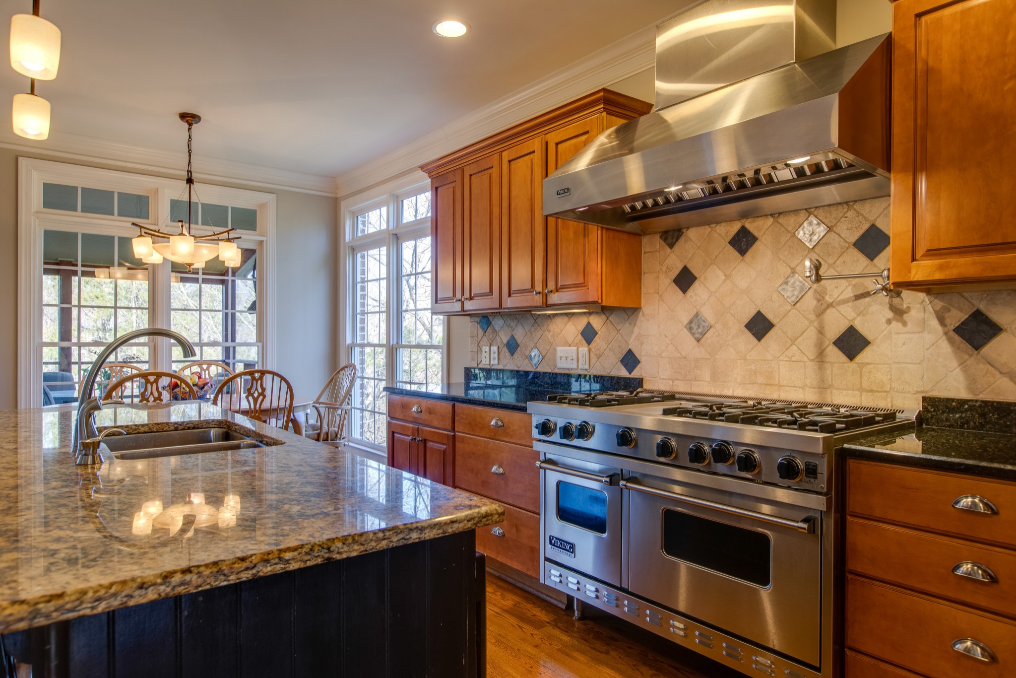 1106 Cedarview Lane Franklin, TN 37067 - Photo 10 of 28 a kitchen with granite countertop a stove a sink and a wooden cabinets