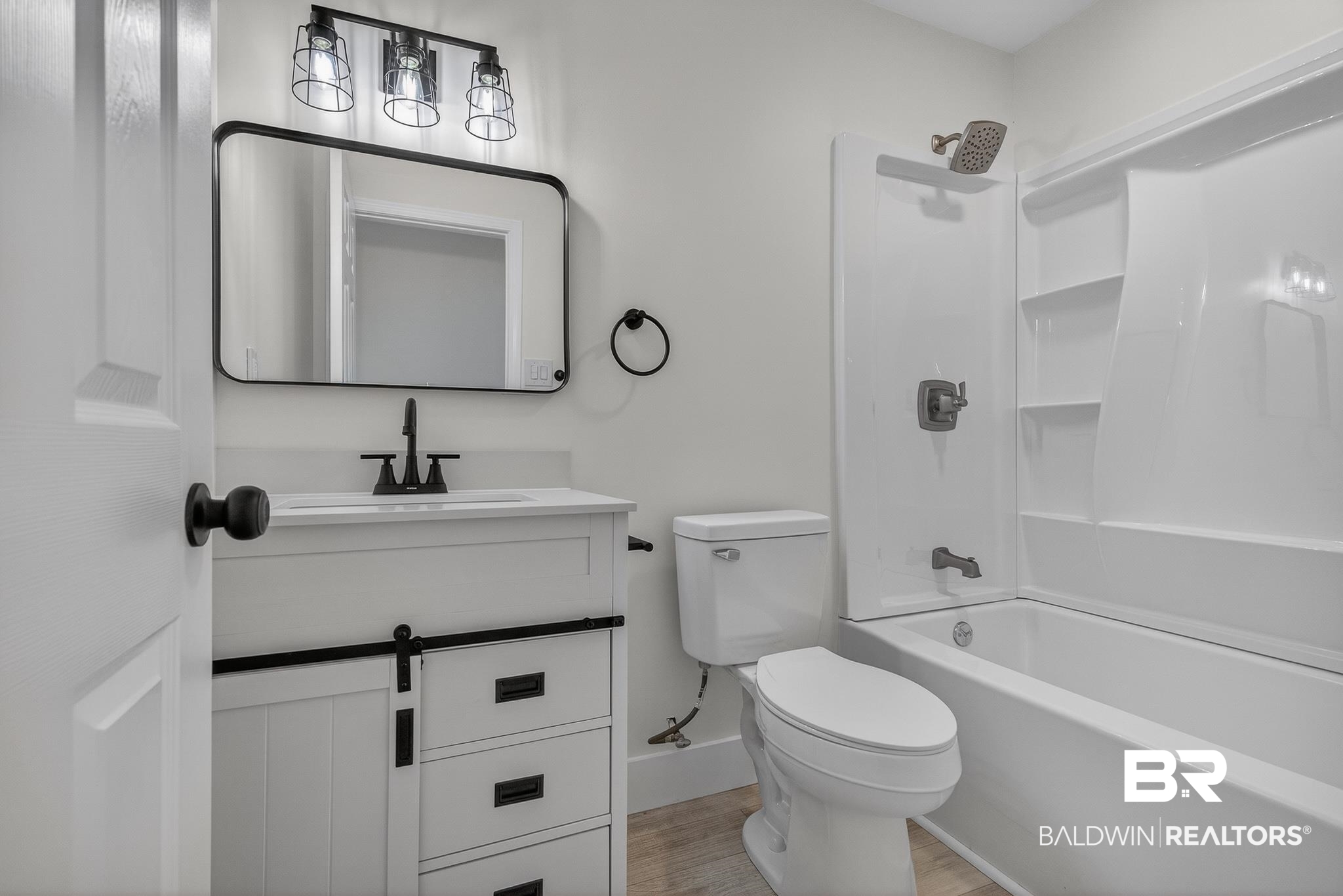10650 Old Pascagoula Road Theodore, AL 36582 - Photo 36 of 77 Bathroom with shower / tub combination, vanity, and light wood finished floors