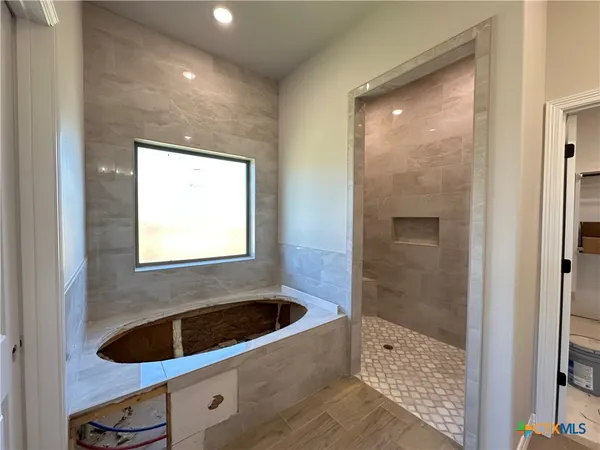 a bathroom with a bathtub and a shower