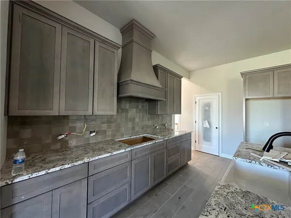 a kitchen with a sink and cabinets