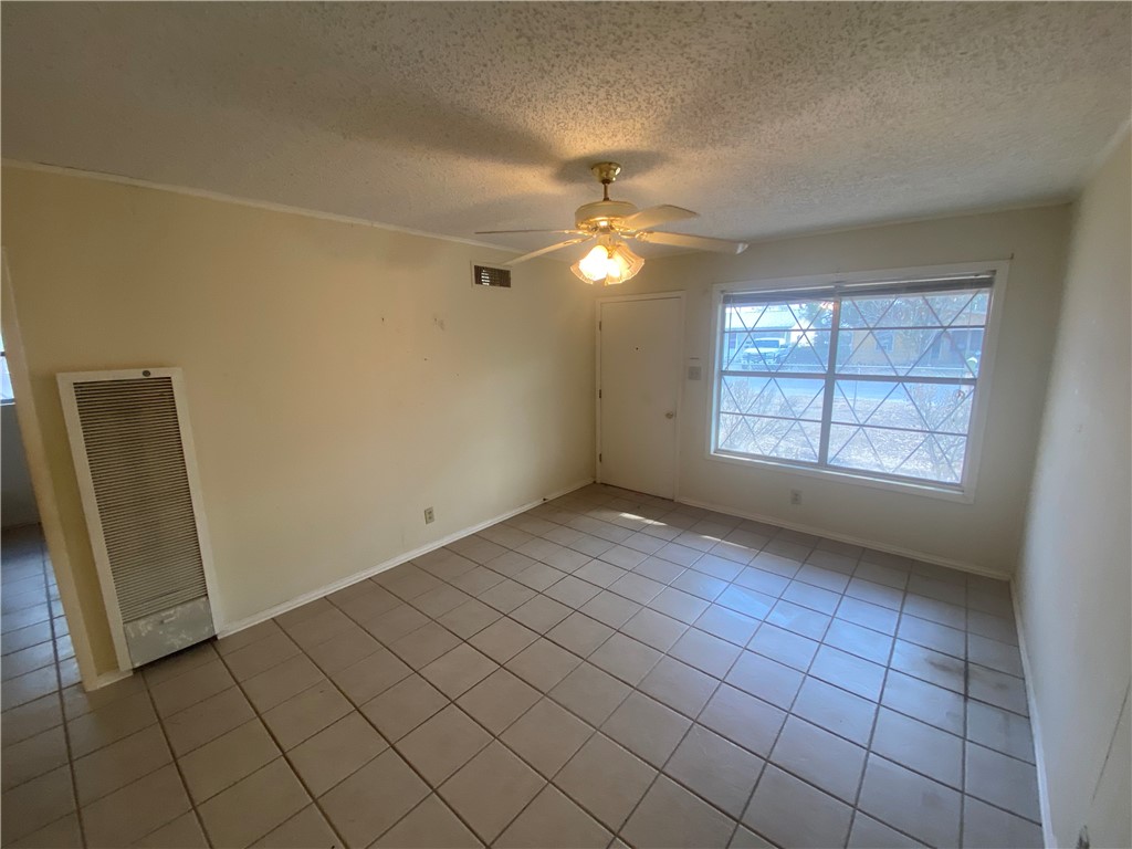 1015 Louis Street Alice, TX 78332 - Photo 9 of 20 an empty room with windows and fan