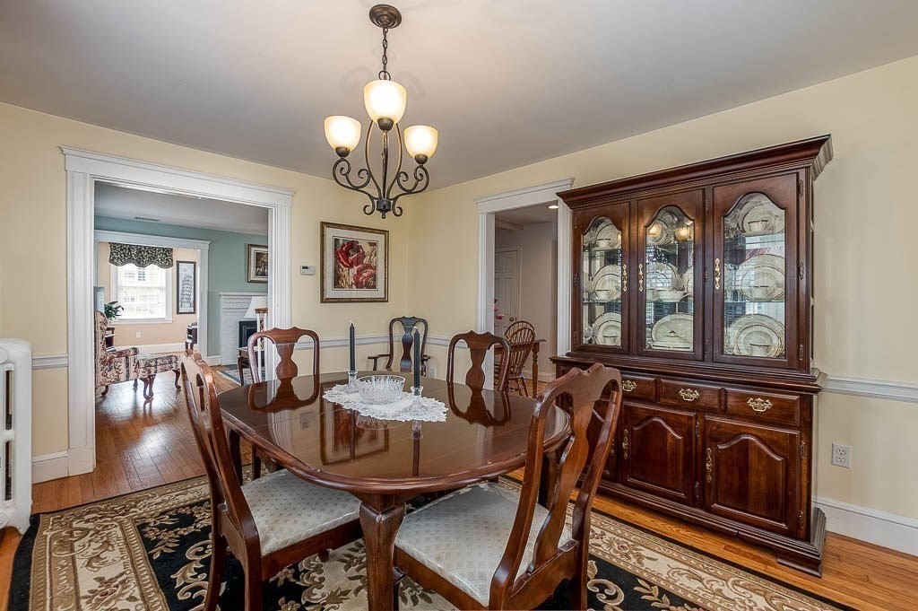 409 Mt Vernon Street Dedham, MA 02026 - Photo 13 of 42 a view of a dining room with furniture wooden floor and chandelier