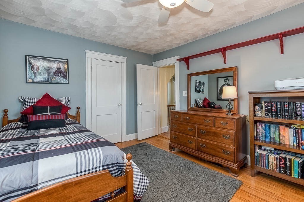 409 Mt Vernon Street Dedham, MA 02026 - Photo 27 of 42 a bedroom with a bed and a book shelf