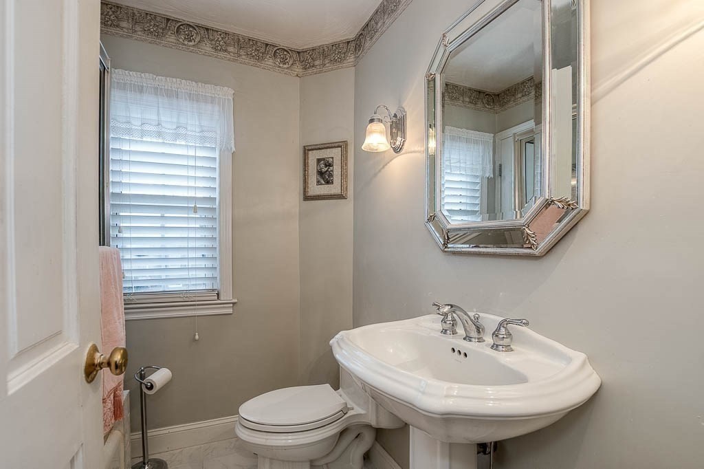 409 Mt Vernon Street Dedham, MA 02026 - Photo 30 of 42 a bathroom with a sink a toilet and mirror