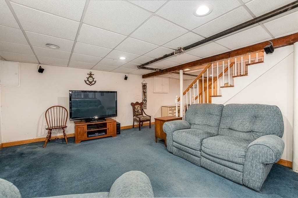 409 Mt Vernon Street Dedham, MA 02026 - Photo 33 of 42 a living room with furniture a flat screen tv and furniture