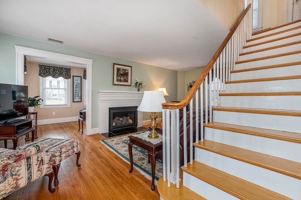 409 Mt Vernon Street Dedham, MA 02026 - Photo 6 of 42 a living room with furniture and a fireplace