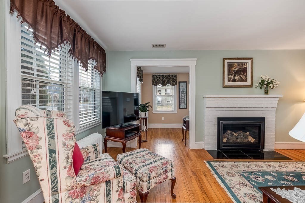 409 Mt Vernon Street Dedham, MA 02026 - Photo 7 of 42 a living room with furniture or fireplace and a fireplace