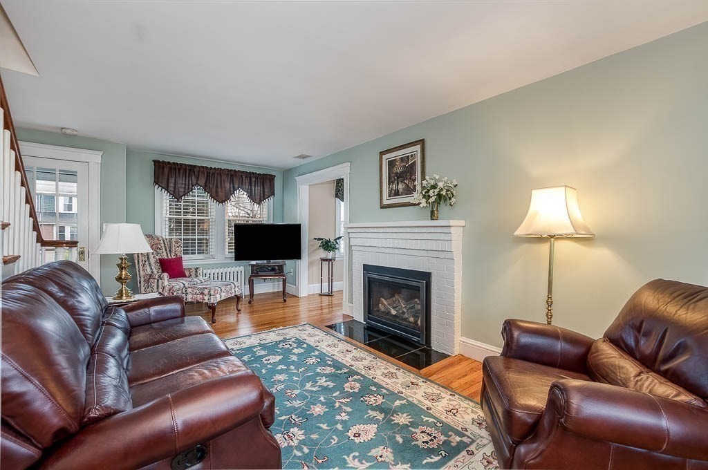 409 Mt Vernon Street Dedham, MA 02026 - Photo 8 of 42 a living room with furniture and a fireplace