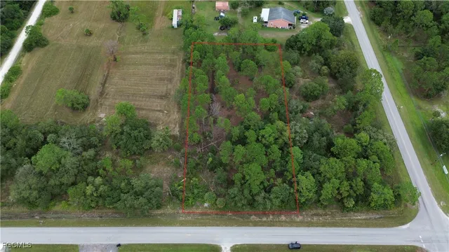 an aerial view of a residential houses with yard