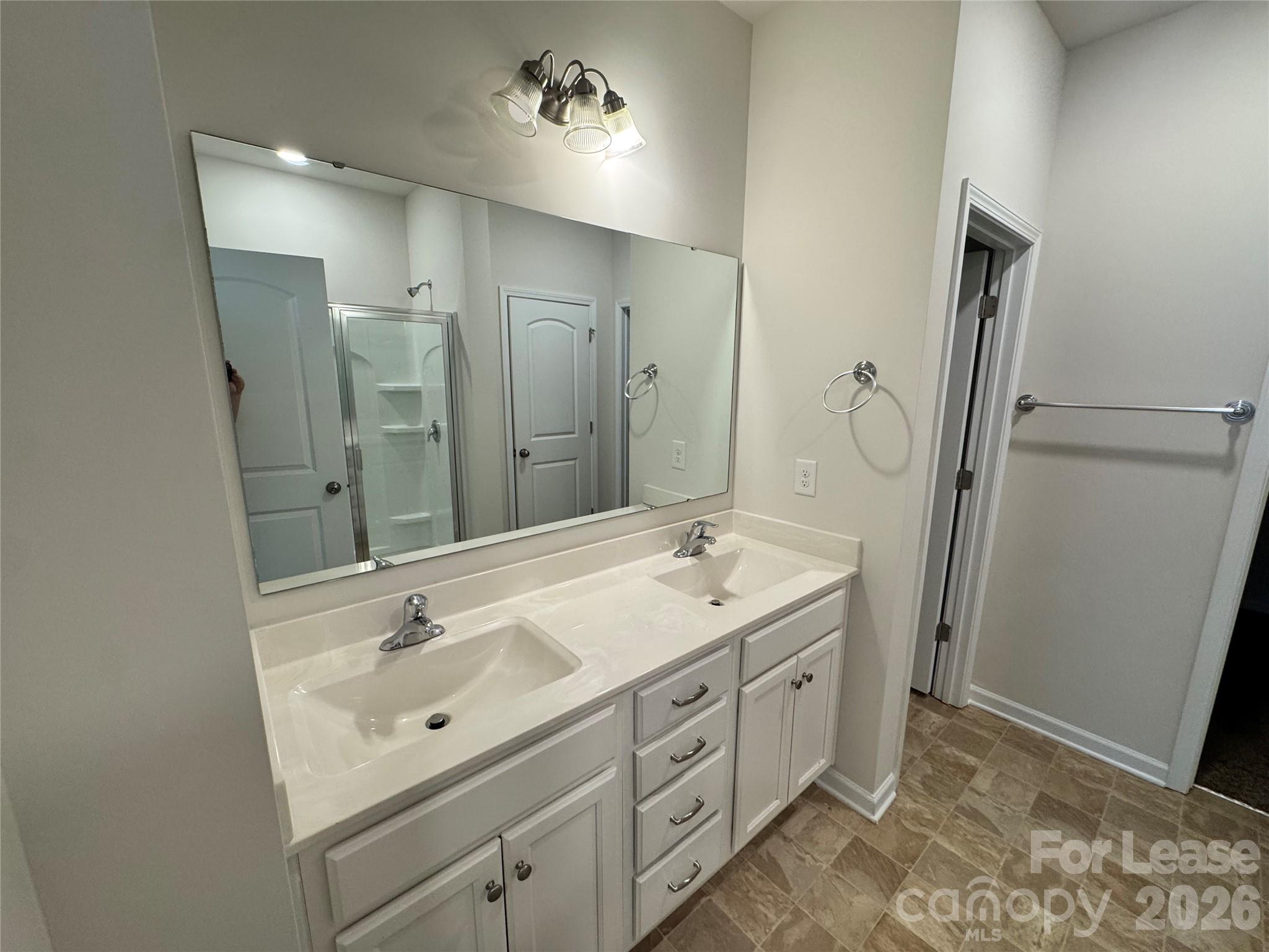 1007 Maylen Trace Monroe, NC 28110 - Photo 12 of 34 a spacious bathroom with a double vanity sink mirror and double