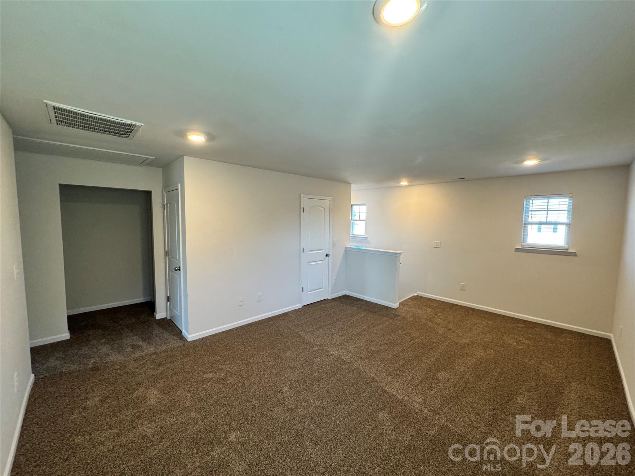 1007 Maylen Trace Monroe, NC 28110 - Photo 20 of 34 an empty room with windows and closet