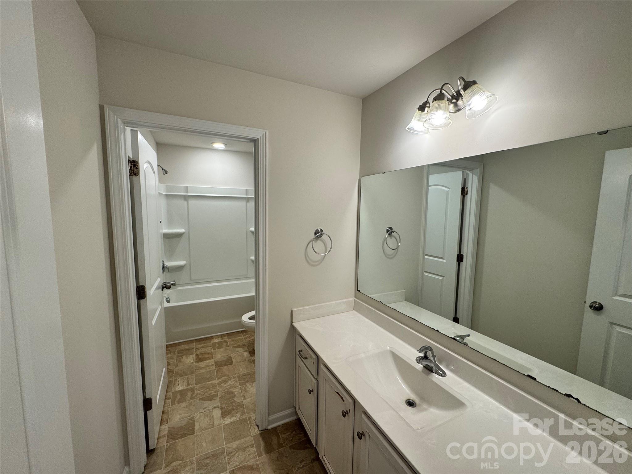 1007 Maylen Trace Monroe, NC 28110 - Photo 26 of 34 a bathroom with a double vanity sink mirror and shower