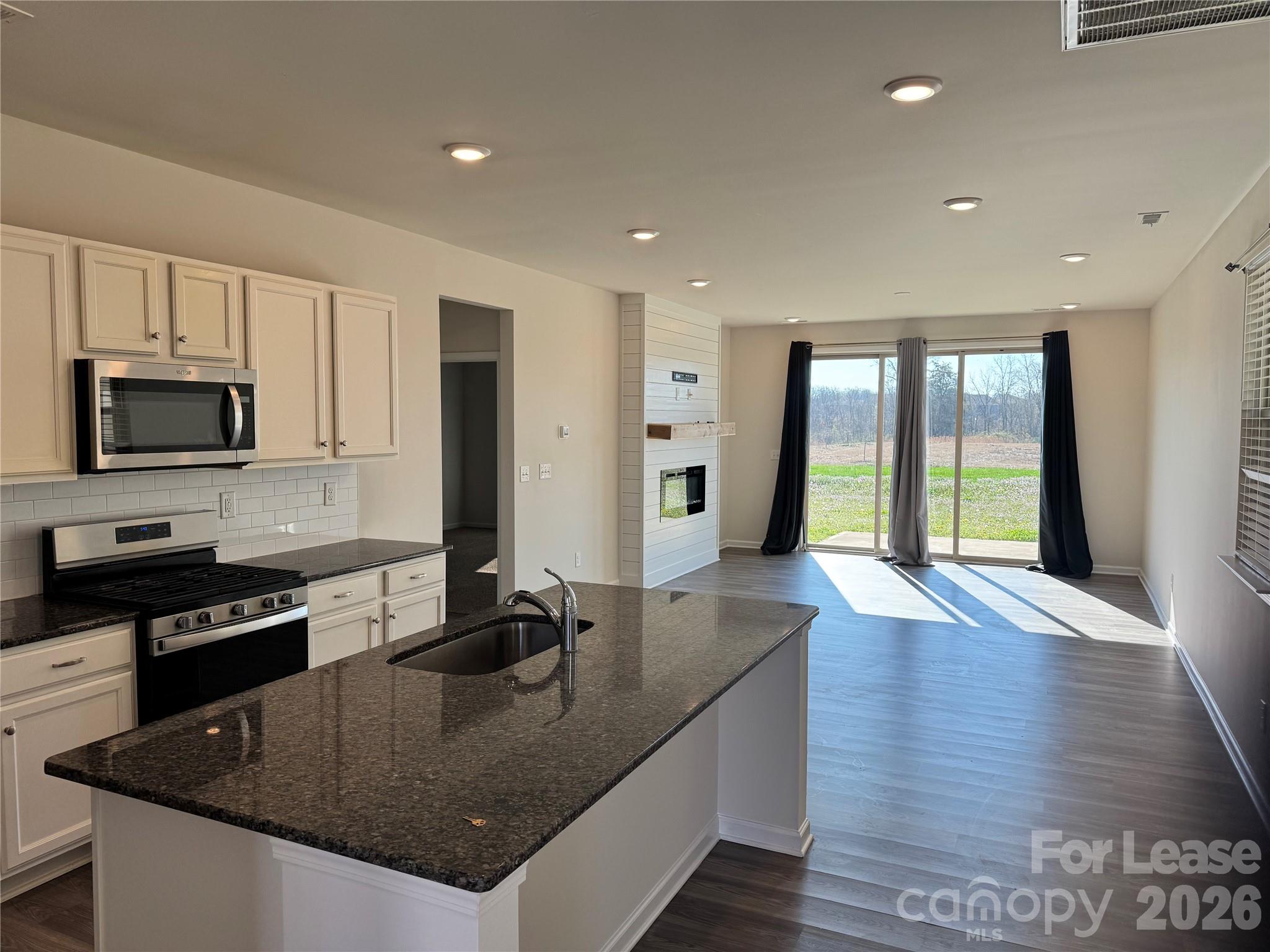 1007 Maylen Trace Monroe, NC 28110 - Photo 3 of 34 a kitchen with stainless steel appliances granite countertop a sink a stove and a granite counter top