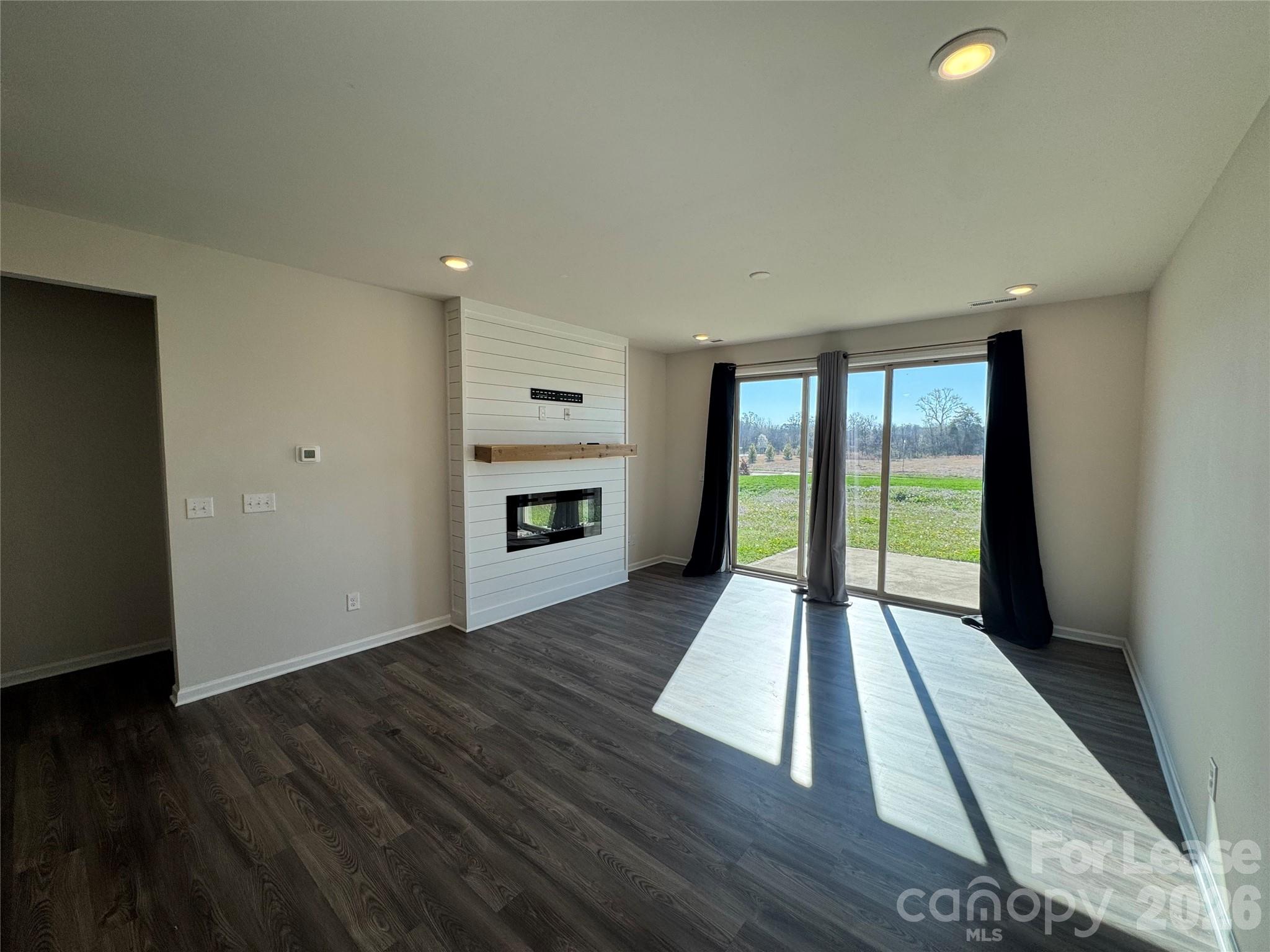 1007 Maylen Trace Monroe, NC 28110 - Photo 9 of 34 wooden floor in an empty room with a window