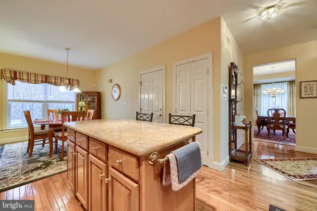 a view of a dining room with furniture a chandelier and wooden floor