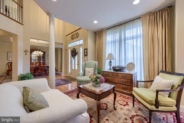 a view of a dining room with furniture and chandelier
