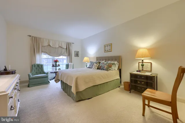 a bedroom with a bed and a night stand