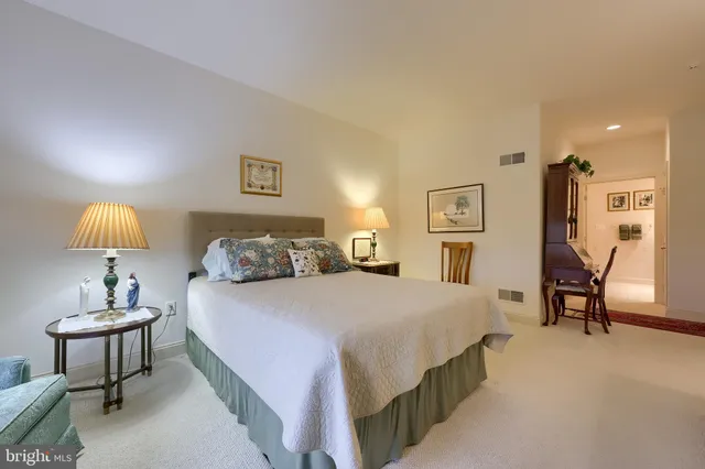 a bedroom with a bed and lamp