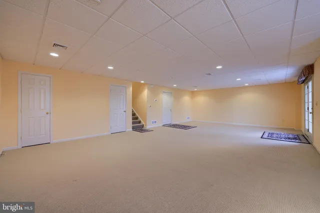 a view of a hallway with a livingroom with furniture