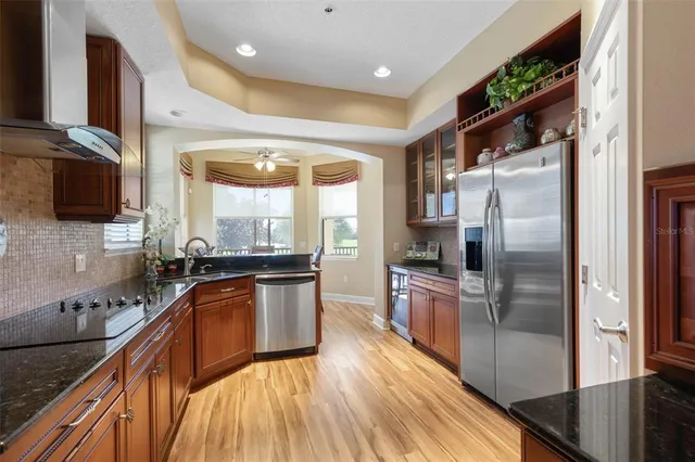 a front view of a house with a yard and potted plants
